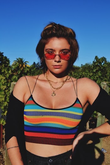 Woman Wearing Striped Crop Top and Blak Cardigan