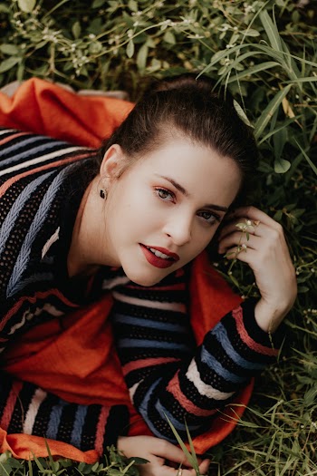 Woman Wearing Striped Long Sleeved Shirt On Grass