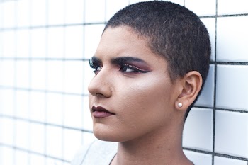 Woman Wearing Stud Earrings Leaning White Tiled Wall