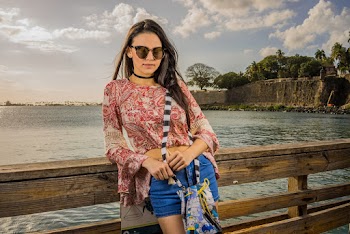 Woman Wearing Sunglasses Leaning On Wooden Fence