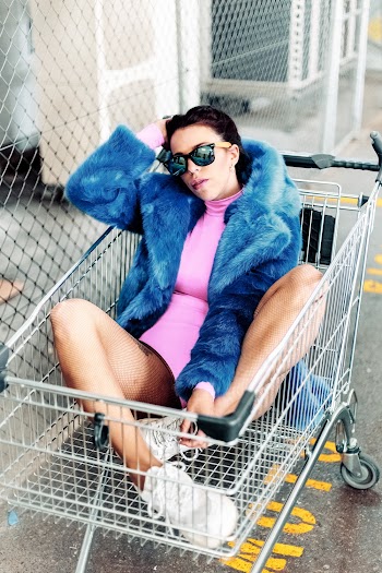 Woman Wearing Sunglasses On Shopping Cart
