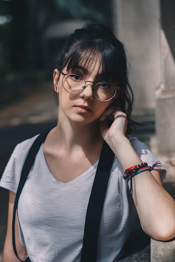 Woman Wearing Suspenders and Eyeglasses