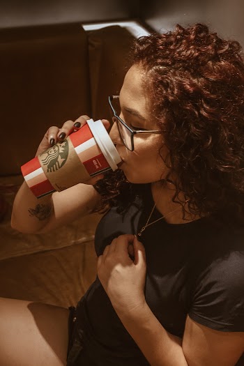 Woman Wearing T-shirt Drinking With Starbucks Cup