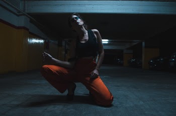 Woman Wearing Tank Top and Kneeling on the Floor
