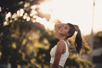 Woman Wearing Tank Top Holding Her Hair