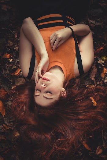 Woman Wearing Tank Top Lying on Ground