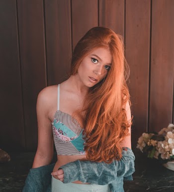Woman Wearing Teal and Black Spaghetti Strap Crop Top