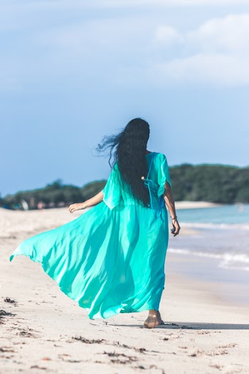 Woman Wearing Teal Dress While Walking Near Body of Water