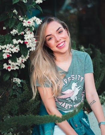 Woman Wearing Teal Shirt Smiling