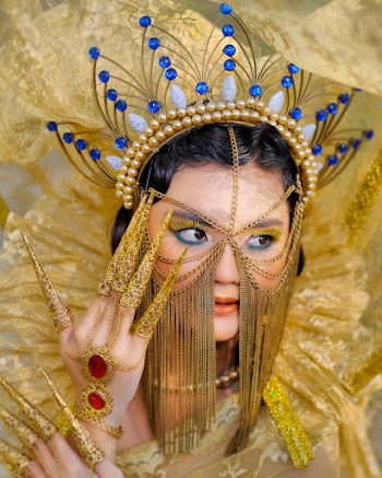 Woman Wearing Traditional Gold Headwre, Finger Accessories, and Necklace