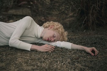 Woman Wearing Turtle-neck Long-sleeved Top Lying on Grass Field