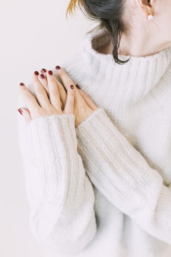 Woman Wearing Turtleneck Sweater in White Surface