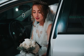 Woman Wearing Wedding Dress Sitting Inside A Vehicle