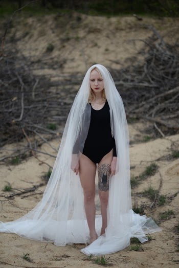 Woman Wearing Wedding Veil and Bodysuit on Shoreline
