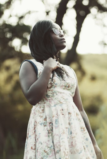 Woman Wearing White and Beige Floral Dress Holding Her Hair