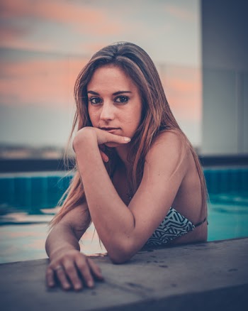 Woman Wearing White and Black Chevron Bikini Top on Swimming Pool Selective Focus Photography