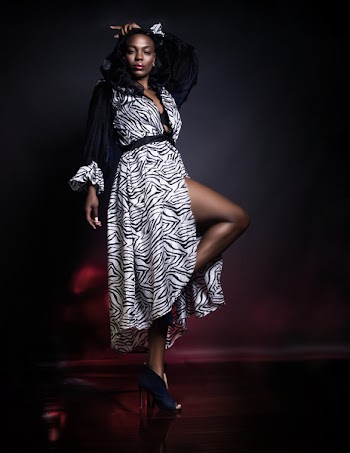 Woman Wearing White and Black Dress While Posing