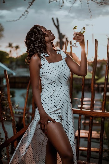 Woman Wearing White and Black Polka-dot Sleeveless Dress