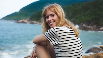 Woman Wearing White And Black Striped T-shirt Sitting Near Body Of Water