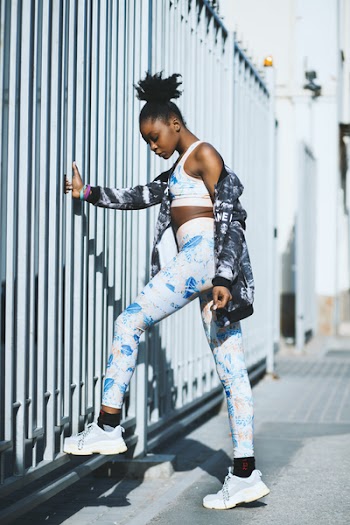 Woman Wearing White and Blue Pants and Pair of Gray-and-white Low-top Sneakers