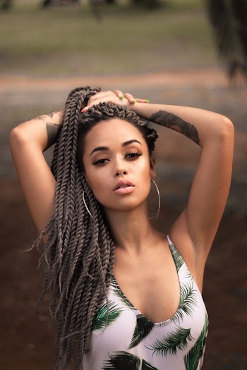 Woman Wearing White and Green Palm Tree Leaf Themed Haltered Tops Putting Both Hand on Head