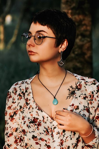 Woman Wearing White and Maroon Floral Top and Brown Sunglasses Looking at Side