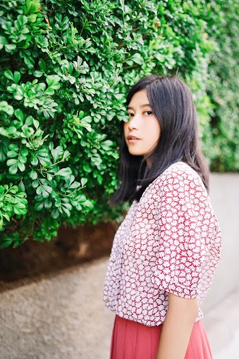 Woman Wearing White and Pink Elbow-sleeved Blouse Standing Near Green Leaf Plant