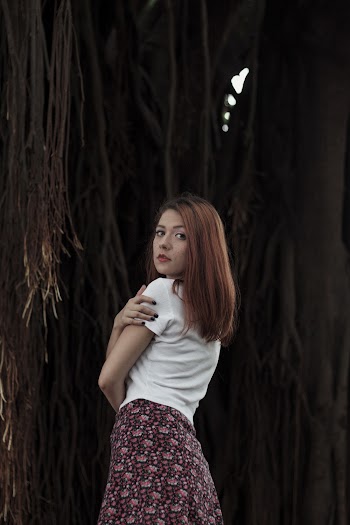 Woman Wearing White Blouse and Maroon Floral Mini Skirt
