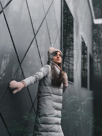 Woman Wearing White Bubble Jacket, Knitted Hat and Gloves