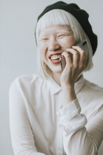 Woman Wearing White Button-up Long-sleeved Shirt Holding Iphone X