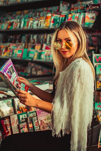 Woman Wearing White Coat Holding Books