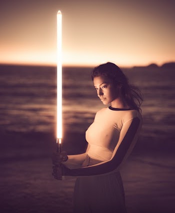 Woman Wearing White Crew-neck Long Sleeved Shirt Holding Sword