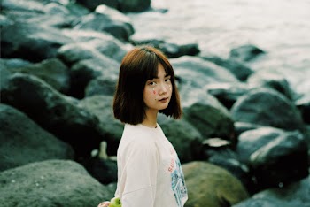Woman Wearing White Crew-neck Shirt Standing on Seashore