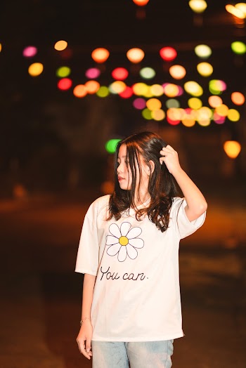 Woman Wearing White Crew-Neck Shirt While Holding Her Hair