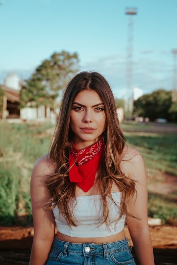 Woman Wearing White Crop Top, Blue Denim Bottoms and Red Bandana