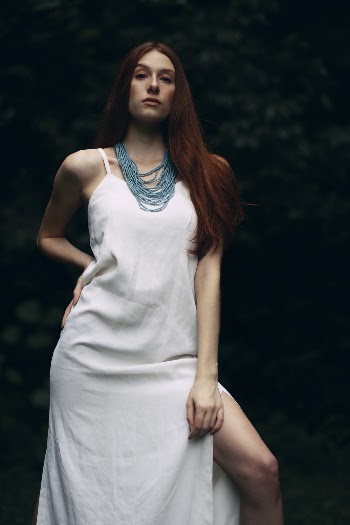 Woman Wearing White Dress and Blue Beaded Necklace