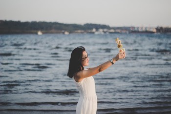 Woman Wearing White Dress Holding Flower Crown