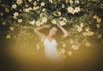 Woman Wearing White Dress Lying on Yellow Flowers