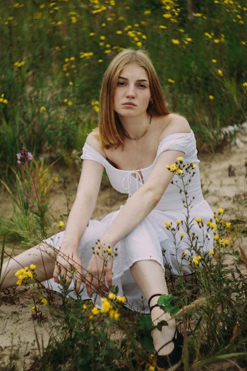 Woman Wearing White Dress Sitting On Soil Pathway 