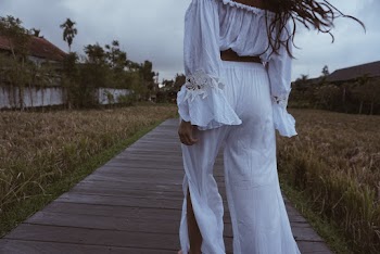 Woman Wearing White Dress Walking in a Pathway