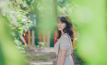 Woman Wearing White Dress With Sling Bag