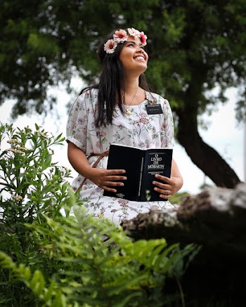 Woman Wearing White Floral Dress Holding Book