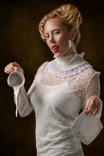 Woman Wearing White Floral Long Sleeve Dress Holding Cup And Saucer