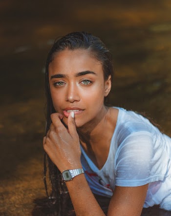 Woman Wearing White Guess Shirt While Holding Her Lips