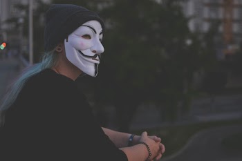 Woman Wearing White Guy Fawkes Mask