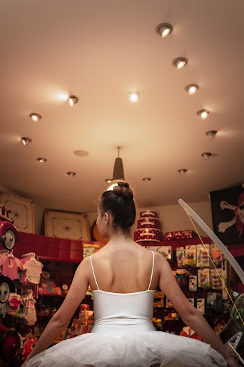 Woman Wearing White Lace-strap Dress in a Well-lit Room