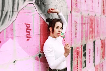 Woman Wearing White Long Sleeve Shirt Holding Lollipop