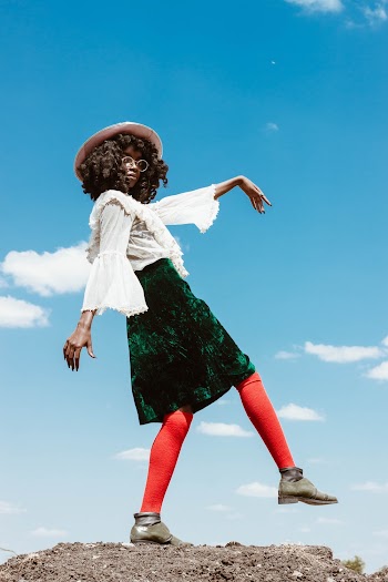 Woman Wearing White Long Sleeve Top and Green Skirt