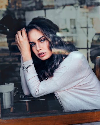 Woman Wearing White Long-sleeved Blouse Sitting Near Black Wooden Table