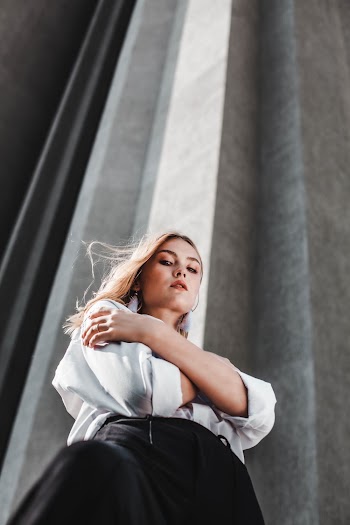 Woman Wearing White Long-sleeved Shirt Looking Down